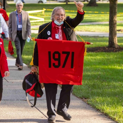 Savage carrying the banner at a Rutgers Reunion