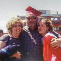 Sisler with her parents at her high school graduation.